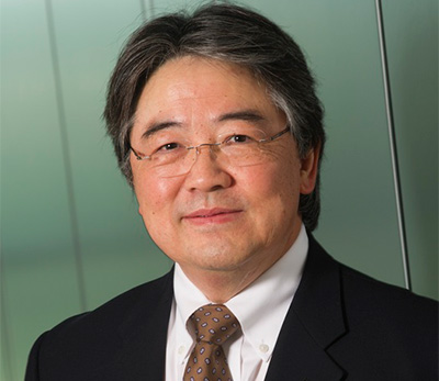 Man in dark grey suit and glasses. 