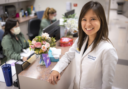 Woman wearing white standing in front of counter