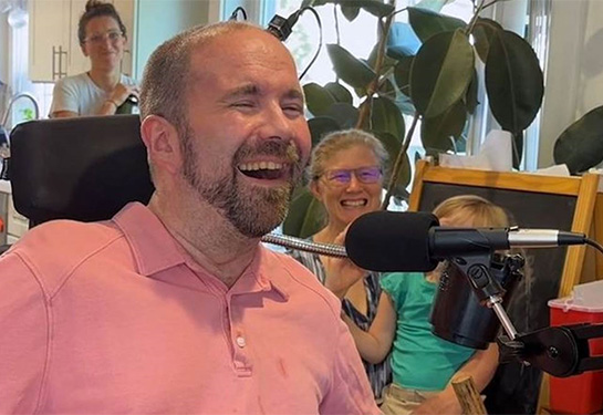 Chris Harrell with his family and caregiver after hearing his voice for the first time.