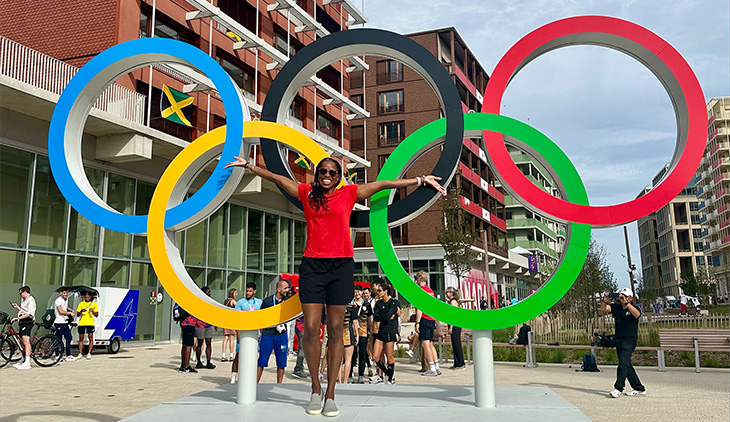 Marcia Faustin in front of the Olympic rings