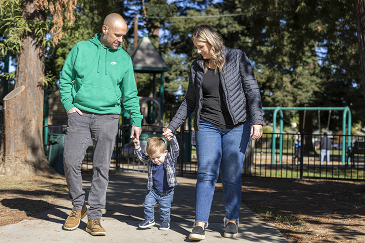 Parents walking with son in the park