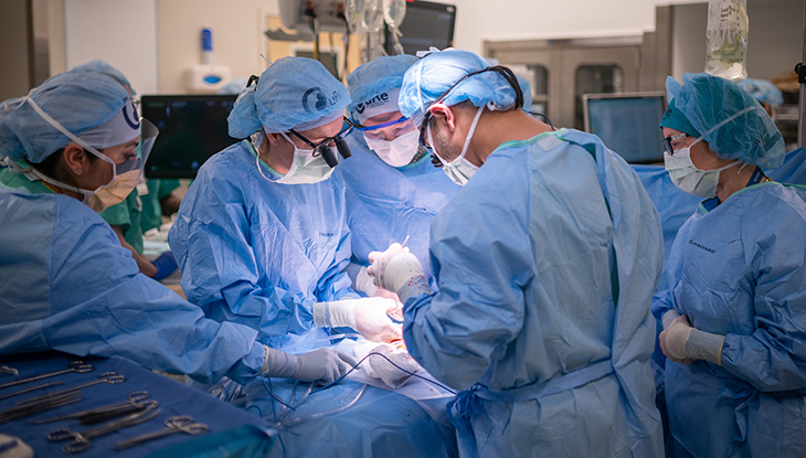 Surgeons in a room performing an operation