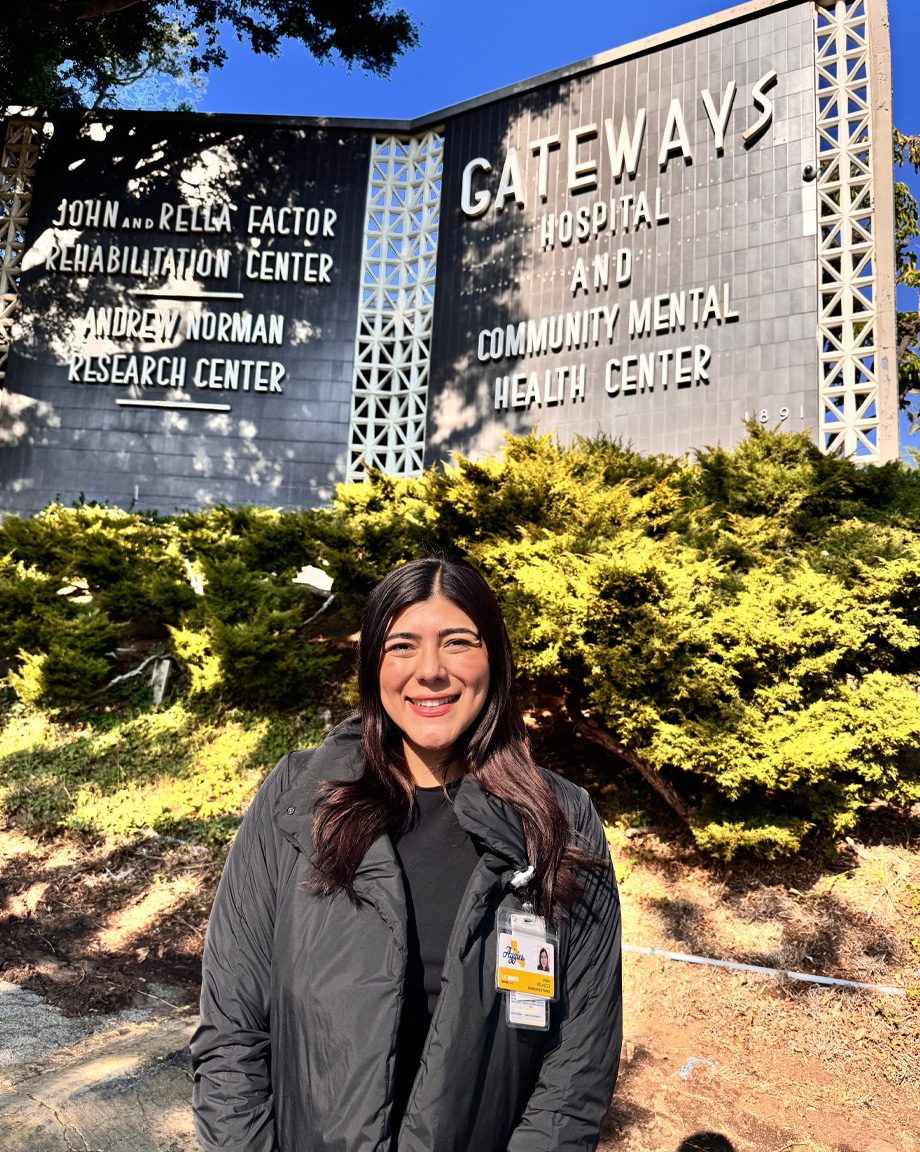 Woman standing in front of hospital sign