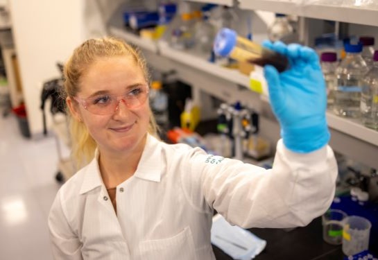 Female lab researcher holding a vile