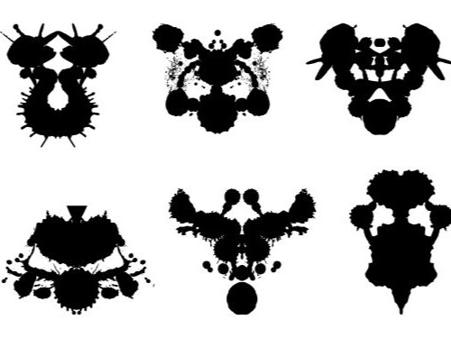 Black Rorschach blots are seen against a white background