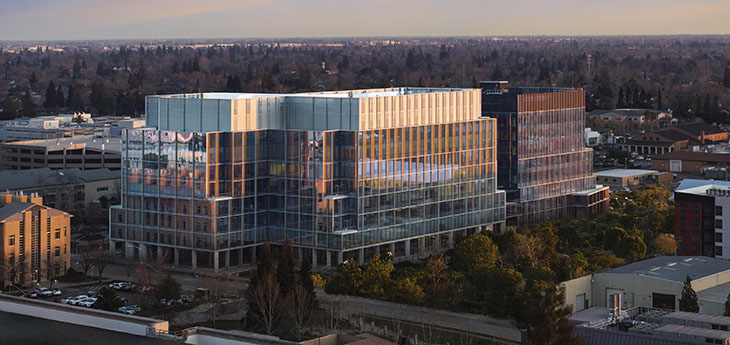 A large glass and metal building on the UC Davis Health campus