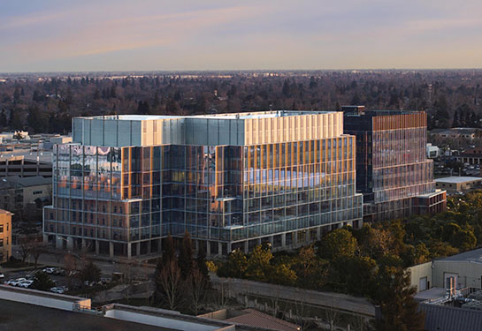 A large glass and metal building on the UC Davis Health campus