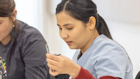 Student works on suturing in skills class