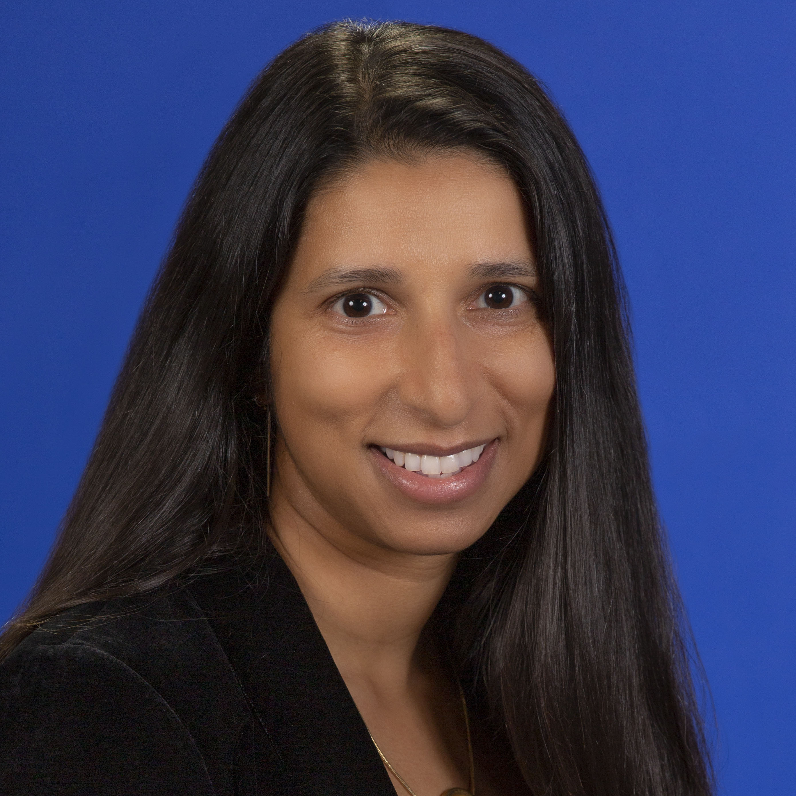 Women with dark hair wearing a lab coat