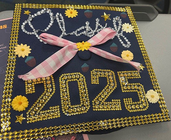 a graduation cap decorated with sparkling gold fake gems