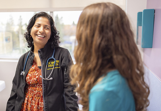 Female doctor with patient in clinic