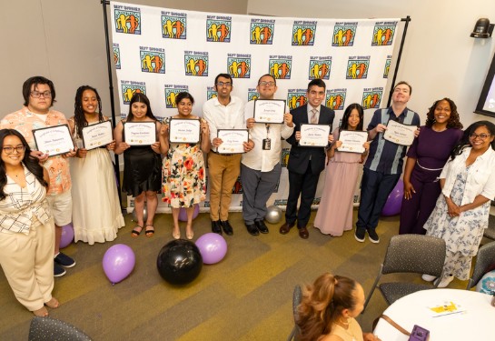 group of interns smiling with certificates