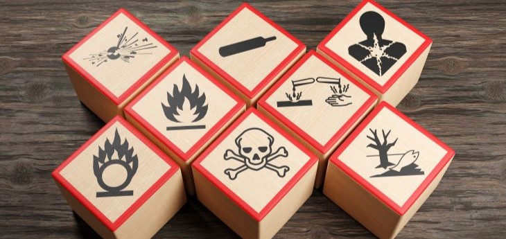 Wooden blocks show symbols for types of chemicals and other hazards.