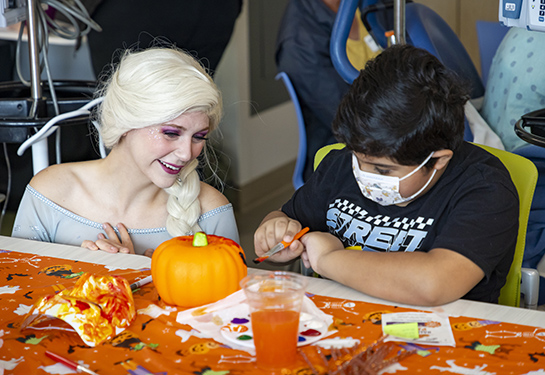 Child wearing mask with Elsa from Frozen