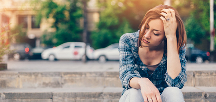 Unhappy thoughtful girl with cigarette