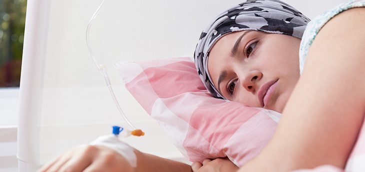 Photo of young pretty cancer girl lying in hospital