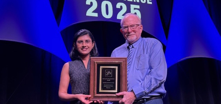 Female and male holding plaque award for neuroscience 2025
