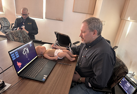 Steven McElroy, chief of neonatology, trains on POCUS.