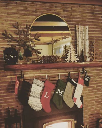 Green and red stockings hanging from the fireplace