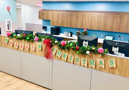 Merry Christmas sign draping over the front of an office