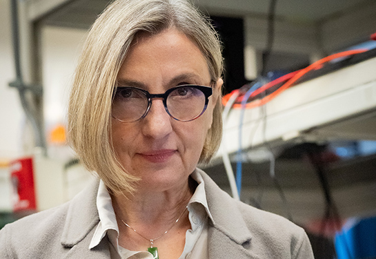 Professor Laura Marcu with a short blond hair looking straight. 