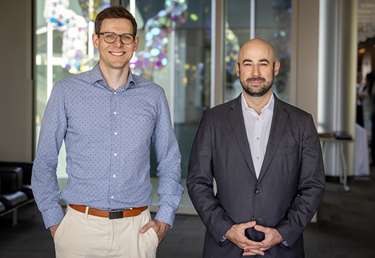 Stavisky and Brandman stand together smiling for the camera