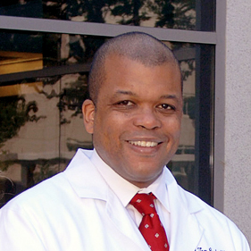 Headshot of Dr. David Cooke in white coat.