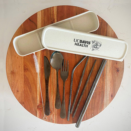 : A reusable utensil kit containing a fork, spoon, knife, chop sticks, straw cleaner and a container to keep them in