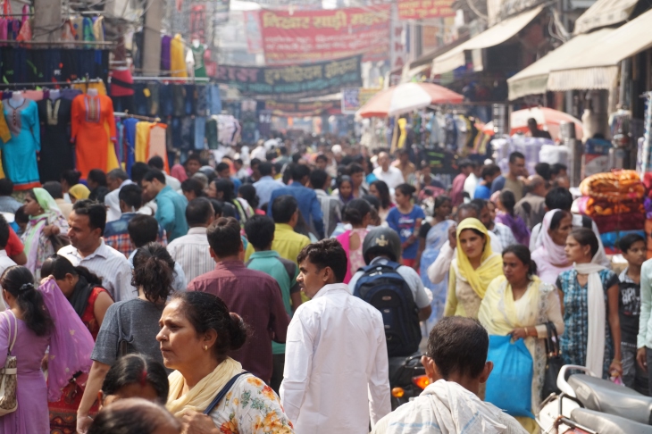 A crowd of people walking in the street in Gurgaon, India.