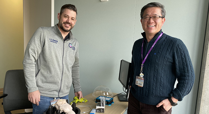 Christopher Pivetti on the left and Aijun Wang on the right of the 3D printed model.
