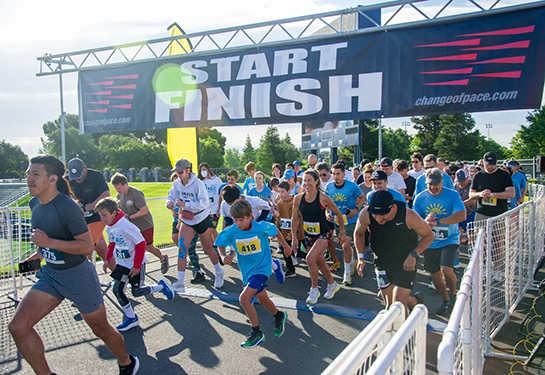 People begin running the race at the start line.