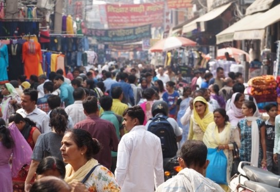 A crowd of people walking in the street in Gurgaon, India.