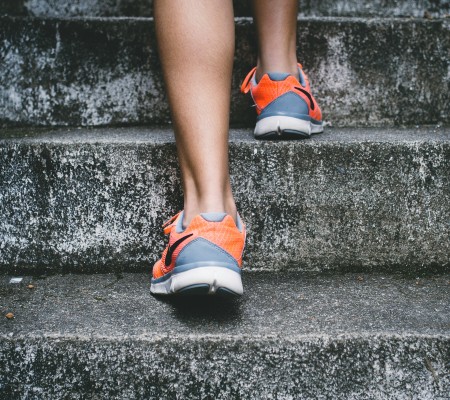 A woman walking up a flight of stairs