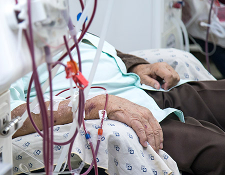 Patient with kidney failure is getting hemodialysis at a clinic.
