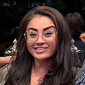 Woman with brown hair and glasses
