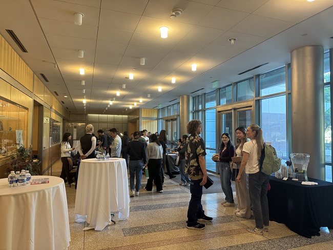 Attendees gather to discuss symposium in the lobby