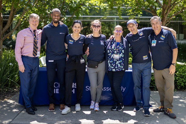 A group of employees pose together for a photo