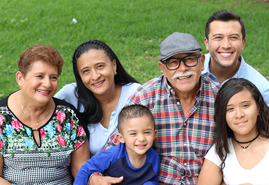 Hispanic family of six: grandparents, parents, a girl, and a little boy