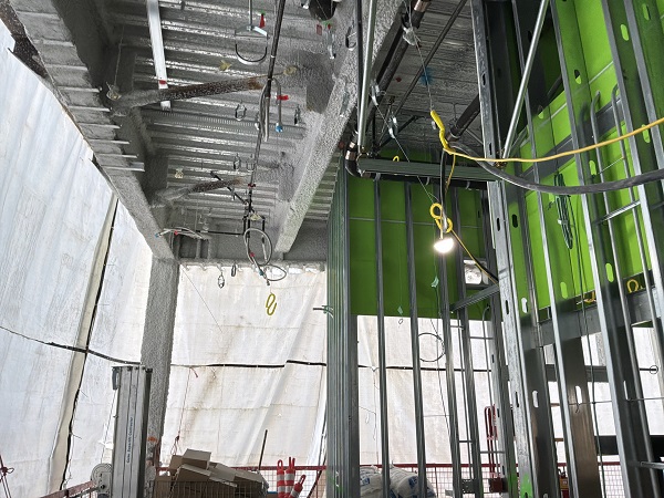 Interior framing view showing metal studs, mechanical systems and unfinished wall assemblies.