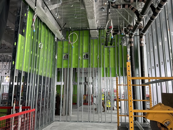 Interior framing view showing metal studs, mechanical systems and unfinished wall assemblies.