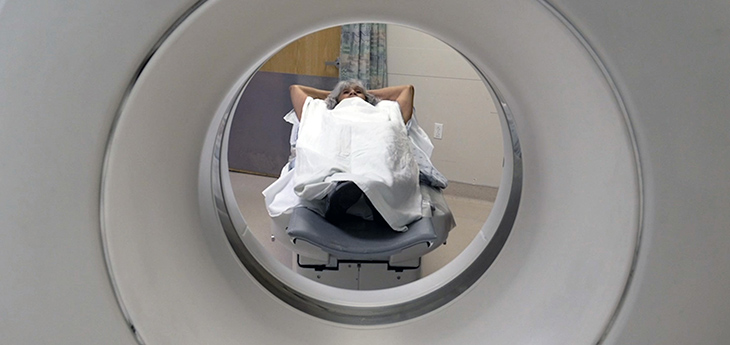 Patient undergoing a CT scan laying down