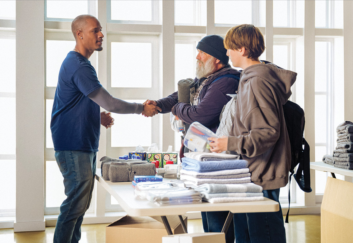 Believe in Better man shaking another man's hand