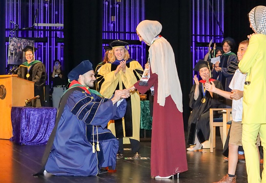 A proposal takes place during School of Medicine's commencement ceremony.