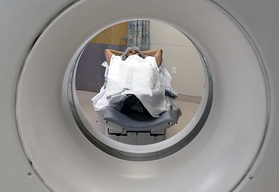 Patient undergoing a CT scan laying down