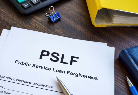 pslf papers on a desk with a pen