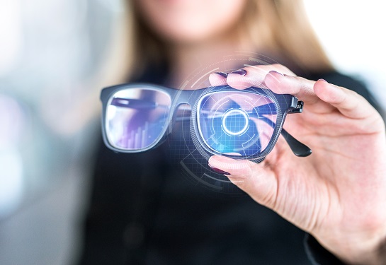 Woman holds up AI glasses