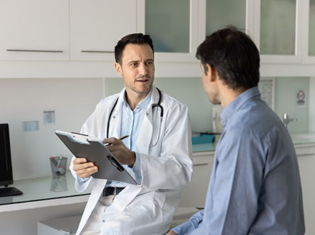 male health care provider talking to man in the clinic about prostate cancer testing