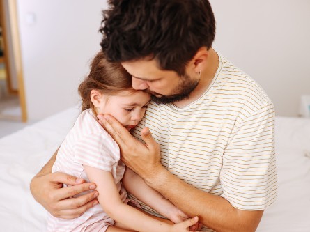 A mom holding a baby with pediatric diarrhea