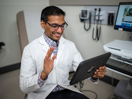 health care provider on a tablet talking with a patient via telehealth