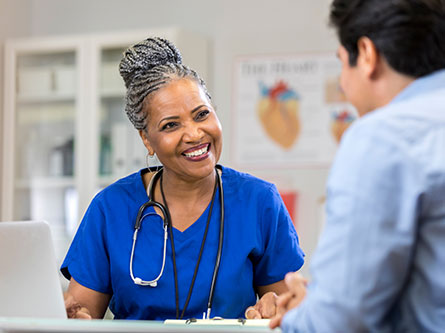 Healthcare provider talking to patient about head and neck cancers